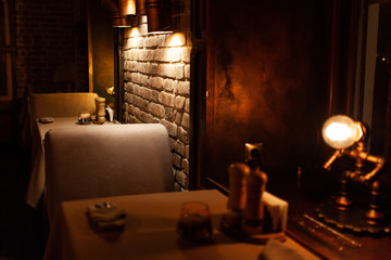 table set by burning candles glasses