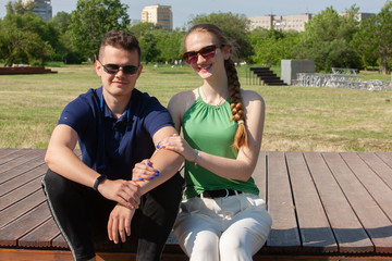 Portrait happy young smiling couple in love over flowering spring garden