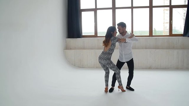 Concept of love, relationships and social dancing. Social dance, salsa, zouk, tango, kizomba concept - beautiful couple dancing bachata