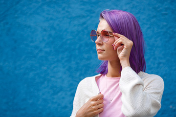 a girl with purple hair in pink glasses