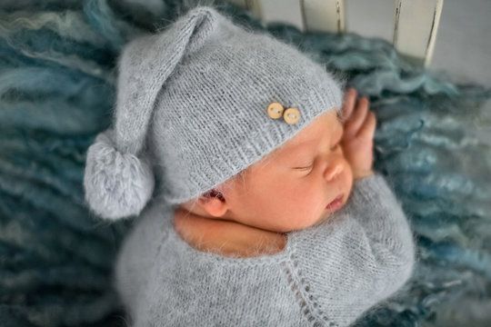 Sleeping newborn boy in the first days of life on white background