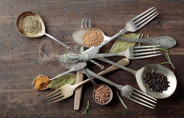 Various herbs and spices on wooden table.