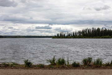 Fototapeta na wymiar View of Astotin Lake on a cloudy day, Elk Island National Park, Alberta, Canada