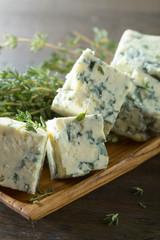 Blue cheese on a wooden table .