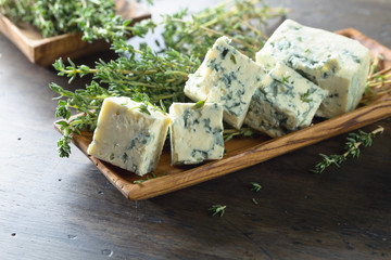 Blue cheese on a wooden table .