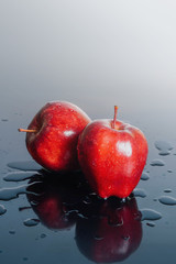 Red apple results on light background With a slight drop of water with dark shadows