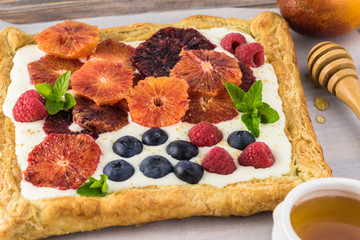 Homemade fresh blood orange, berries tart.