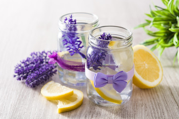 Obraz na płótnie Canvas Lavender lemonade drink in jar on white wooden table