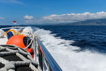 BALI, INDONESIA - December 01, 2013: Approaching the coast of Lombok, Balis neighbouring Island, by Boat on a beautiful day blue skies.