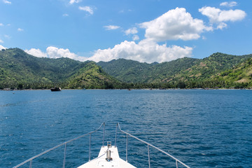 BALI, INDONESIA - December 01, 2013: Approaching the coast of Lombok, Balis neighbouring Island, by Boat on a beautiful day blue skies.