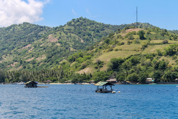 BALI, INDONESIA - December 01, 2013: Approaching the coast of Lombok, Balis neighbouring Island, by Boat on a beautiful day blue skies.