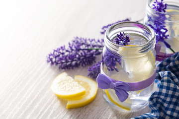 Obraz na płótnie Canvas Lavender lemonade drink in jar on white wooden table. Copyspace