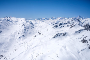 Obraz premium power lines crossing san Giacomo pass covered with sping snow, Ticino, Switzerland
