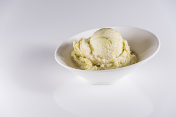 Genuine Italian frozen ice cream with green ice cream pistachio or mint..Delicious frozen icecream..White surface bright background