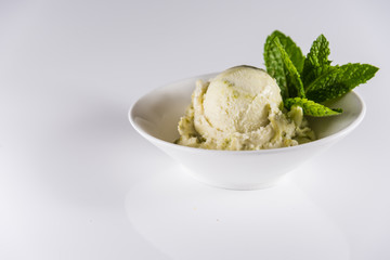 Genuine Italian frozen ice cream with green ice cream pistachio or mint..Delicious frozen icecream..White surface bright background