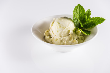 Genuine Italian frozen ice cream with green ice cream pistachio or mint..Delicious frozen icecream..White surface bright background