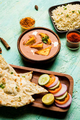 Paneer Butter Masala is a popular North Indian recipe for lunch/dinner made using cottage cheese in red tomato curry. usually served with Rice and chapati/naan. selective focus