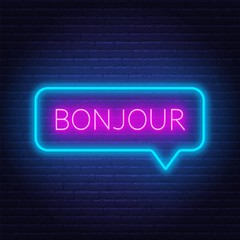 Neon sign of word bonjour in speech bubble frame on dark background. Greetings in French. Light banner on the wall background. © TanyaFox