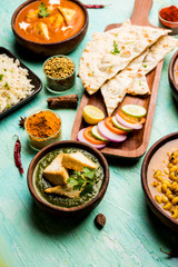 Group of Indian food like Palak Paneer Butter Masala, Choley/chola and Black Eyed Kidney Beans curry with Naan and Rice