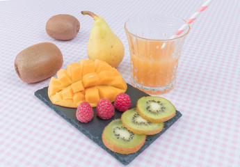 Fruit plate with berries, mango and kiwi. Delicious fruit punch. Selective focus