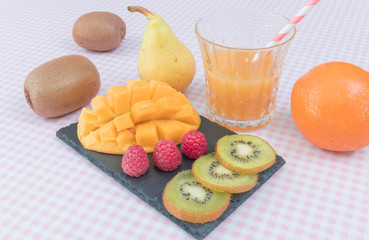 Fruit plate with berries, mango and kiwi. Delicious fruit punch. Selective focus