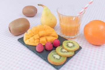 Fruit plate with berries, mango and kiwi. Delicious fruit punch. Selective focus