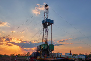 oil rig for drilling under oil and gas at sunset. Drilling oil and gas wells