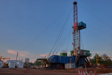 Fototapeta na wymiar oil rig for drilling under oil and gas at sunset. Drilling oil and gas wells