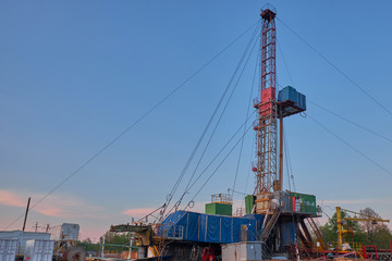 oil rig for drilling under oil and gas at sunset. Drilling oil and gas wells