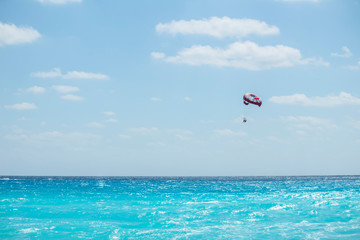 Parasail is flying over the Cancun caribbean sea