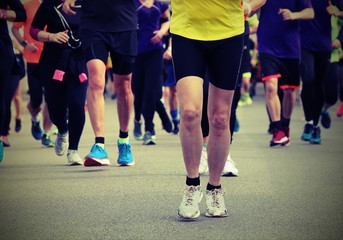 people with sport shoes during a race with old toned effect