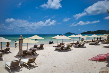 Phu Quoc island, Vietnam - March 31, 2019: A beach of white sand, equipped with sun loungers and umbrellas for relaxing. Beautiful coast of the South China Sea