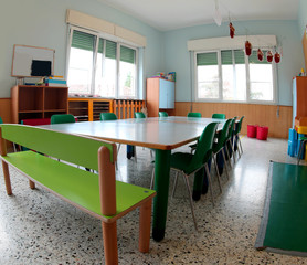 Classroom of a school with green chairs and small table