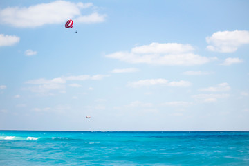 Fototapeta na wymiar Parasail is flying over the Cancun caribbean sea