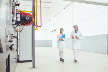 Two technologists at the food factory.