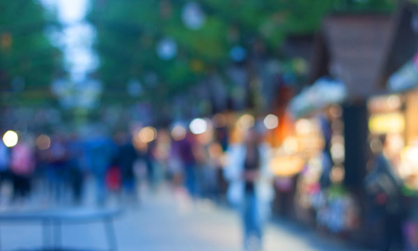 Defocused image of the street summer food festival in the evening