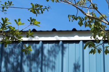 Top of blue garage against the blue sky 