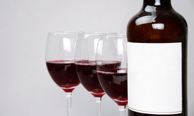 A glass and bottle of red wine