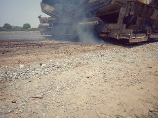 Road maintenance by burning old materials and improving quality - obrazy, fototapety, plakaty