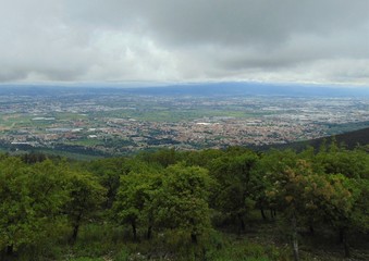 Obraz premium Panoramic view from the mountains Monte Morello to the part of Florence and the neighborhood on a rainy overcast weather with storm clouds. Italy.