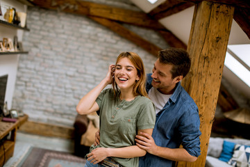 Young couple embracing each other at home