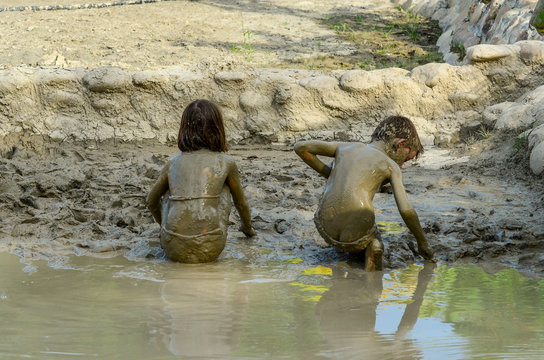 Kids Playing In The Mud