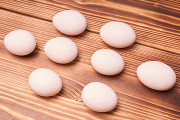 Chicken eggs laid on a wooden table