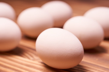 Chicken eggs laid on a wooden table