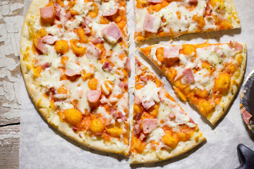 Pizza with cheese, ham and prosciutto