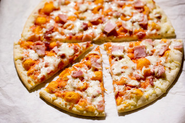 Pizza with cheese, ham and prosciutto