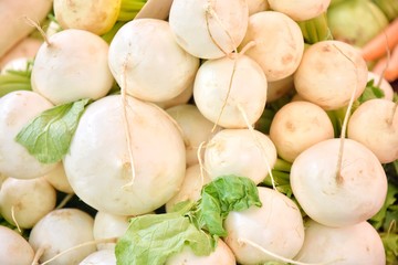 White fresh turnip with selective focus at the farmers market. Organic white radish for healthy...