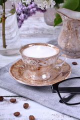 Freshly brewed coffee with a milky foam in a brown cup