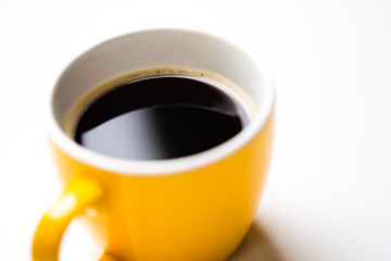 Yellow ceramic coffee espresso cup on white background