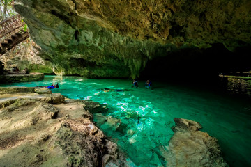 Some people is swimming and snorkeling on Gran Cenote Yucatan